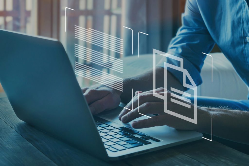 man entering data on laptop