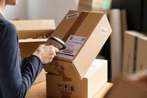 A parcel being scanned by a young lady